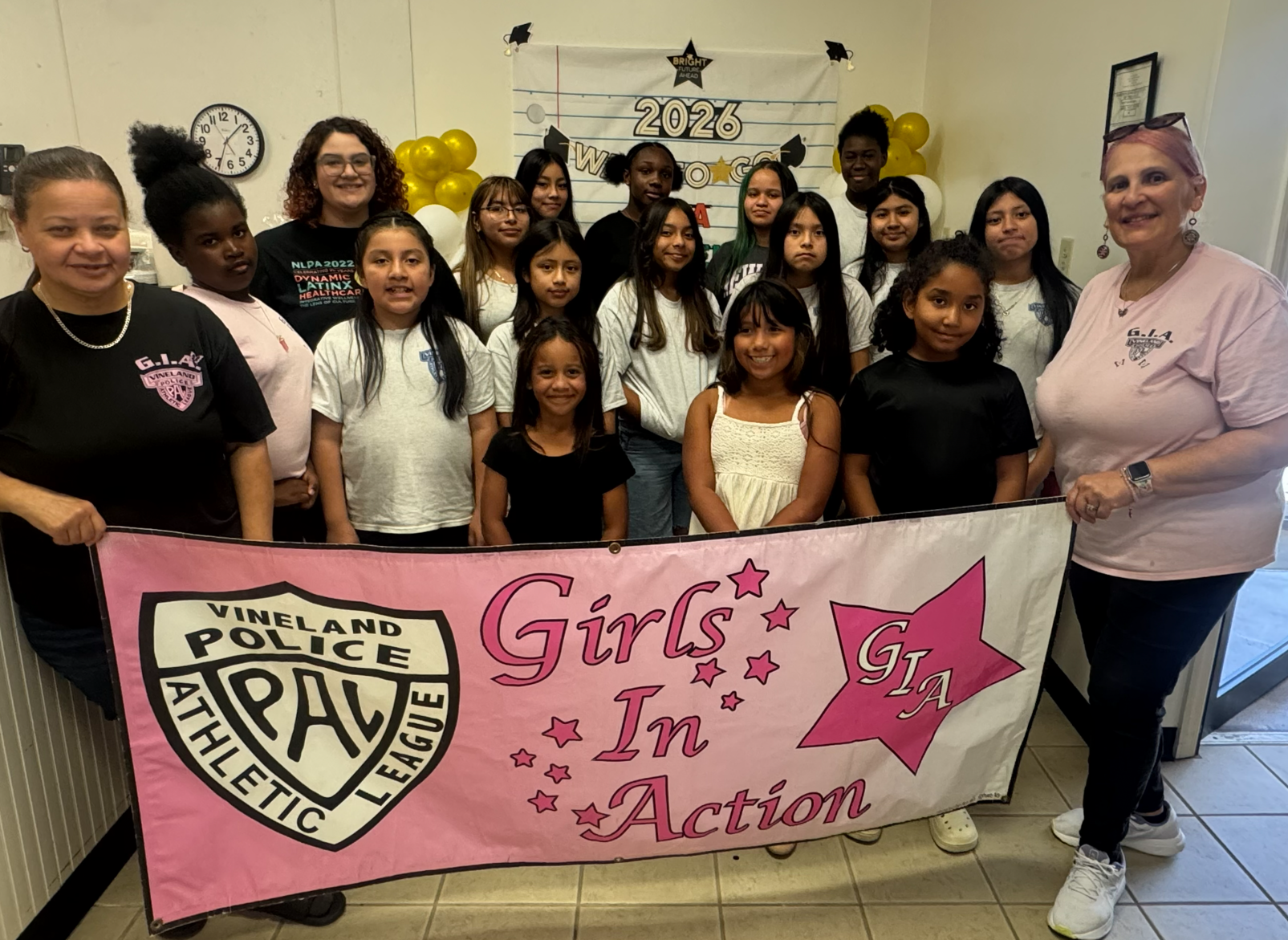 Vineland PAL Girls in Action group with Girls in Action banner